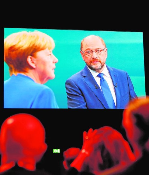 Los periodistas siguen el debate Merkel-Schilz. :: Reuters
