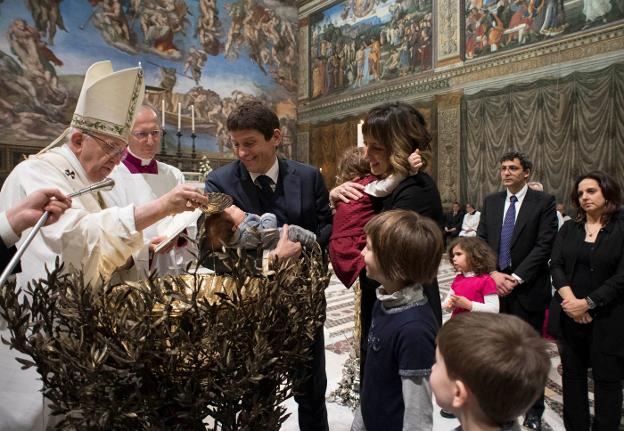 El papa Francisco bautiza a un niño ayer en la Capilla Sixtina. :: afp/