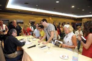 El escritor firma ejemplares de su libro tras la presentación en el hotel Montera Plaza./