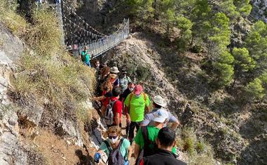 Colas para acceder al puente colgante sobre el río Almanchares, este sábado./E. CABEZAS