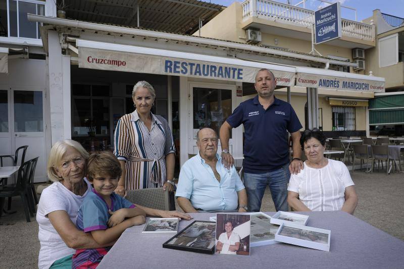 Juan Carretto's family poses with his portrait in front of the Family Beach Bar in Pedregalejo. 